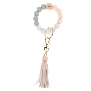 Detail of colorful silicone beaded keychain with wooden bead and pink leather tassel