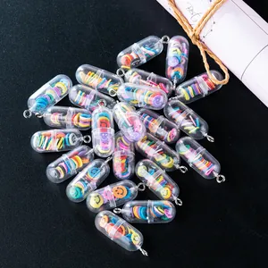 Macro view of transparent pill charms with colorful smiley faces and metal loops