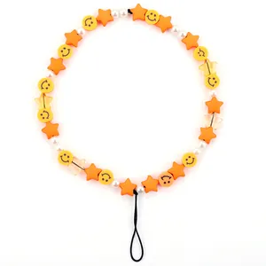 Macro view of colorful beaded phone strap with yellow smiley faces and star beads