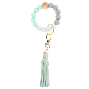 Close-up of mint green silicone beads wristlet keychain with wooden bead and tassel