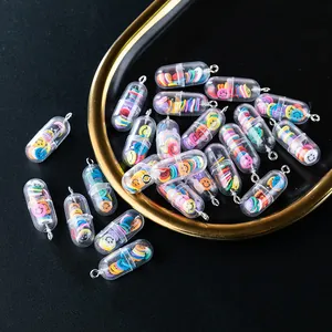 Macro detail of cute pill capsule pendants with colorful smiley face fillings and silver rings