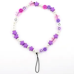 Detailed macro view of colorful smiley face beads and purple stars on the phone lanyard