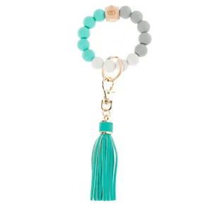 Detail of beaded keychain bracelet with silicone beads, wooden eye bead, and tassel