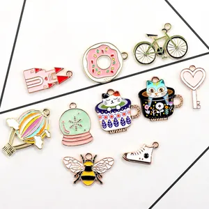 Detailed set of ten colorful enamel alloy pendants featuring donuts, cats, and balloons