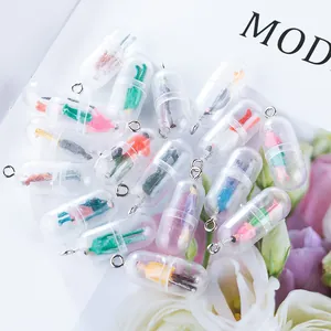 Close-up of creative capsule pendants with miniature colorful figures and metal rings
