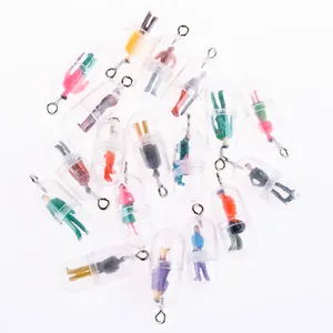 Detailed view of colorful miniature figures inside clear pill capsule pendant charms