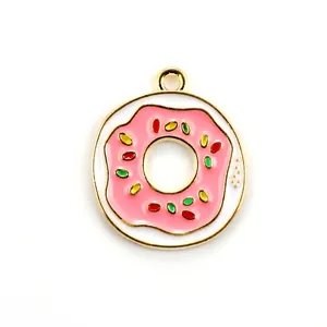 Close-up of pink and white enamel donut charm with colorful sprinkles and gold ring