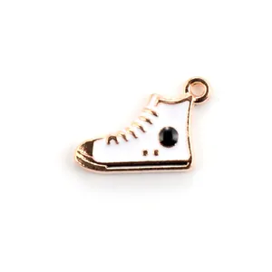 Macro shot of white high-top sneaker charm with gold trim and enamel details for DIY jewelry