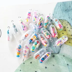 Macro detail of DIY capsule pendants with colorful miniature figures and fruit slices inside
