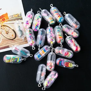 Macro detail of DIY pill capsule charms with colorful fruit slices and metal loops