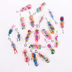Macro shot of creative transparent pill charms with mini fruit and character fillings