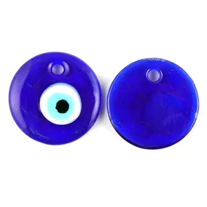 Detailed close-up of blue glass evil eye pendants with pre-drilled holes for jewelry making