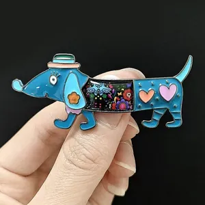Vista macro de broche de perro salchicha de esmalte azul con motivos florales