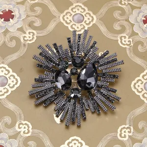 Detailed macro view of a vintage dark grey sunflower brooch with shiny crystal rhinestones