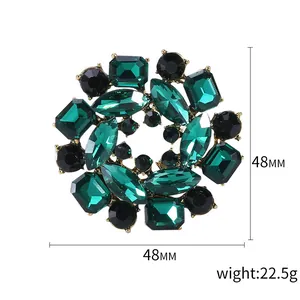 Floral alloy brooch with emerald green crystals and black gems, 48mm round design