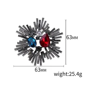 Vintage sunburst brooch with red and blue stones and sparkling rhinestones 63mm