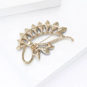 Detailed back view of vintage gold alloy brooch featuring secure swivel pin clasp