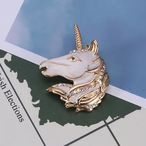 Macro detail of unicorn brooch with colorful rhinestones and gold-plated enamel finish