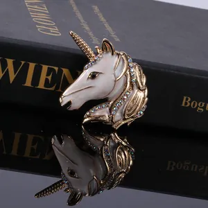 Detailed close-up of a unicorn brooch with colorful rhinestones on a black book