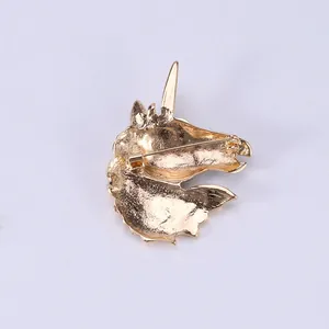 Back view of golden unicorn enamel brooch showing secure metal pin clasp fastener