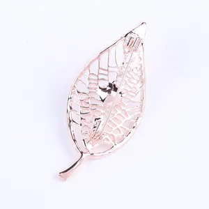 Rose gold hollow leaf brooch showing the back pin mechanism and intricate texture