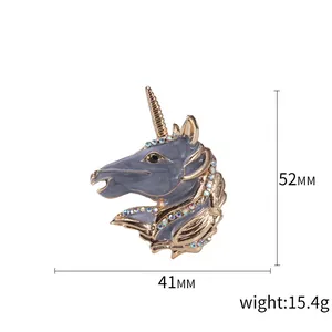 Blue enamel unicorn brooch with gold trim and colorful rhinestones on a white background