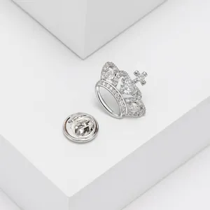Macro detail of silver crown brooch with heart-shaped stone and micro-pave zircons