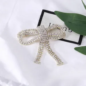 Elegant silver bow brooch with sparkling rhinestones and delicate tassel for clothing