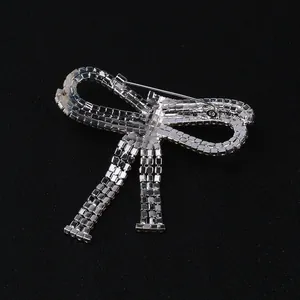 Elegant silver bow brooch with tassels and rhinestones shown from the back view