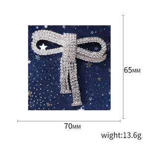 Elegant silver bow brooch with pavé rhinestones and tassels, 70mm width 65mm height
