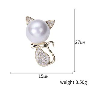 Cute cat brooch with large pearl head and zircon details on golden metal base