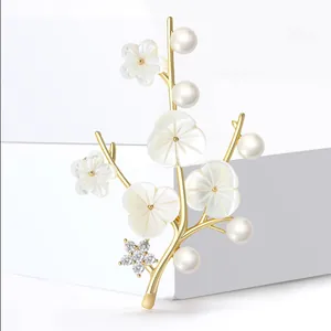 Elegant gold winter plum brooch with freshwater pearls and shell flower petals