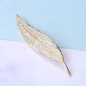 Detailed view of leaf brooch featuring micro-pave white zircons on gold-plated alloy
