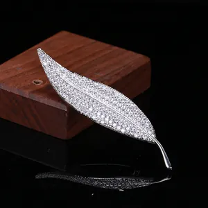 Macro shot of silver leaf brooch featuring intricate pave-set cubic zirconia crystals