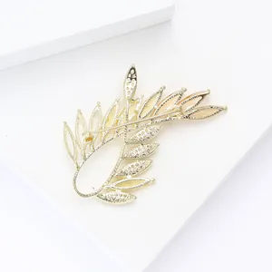 Detailed back view of gold olive branch brooch showing pin clasp and hollow leaf texture