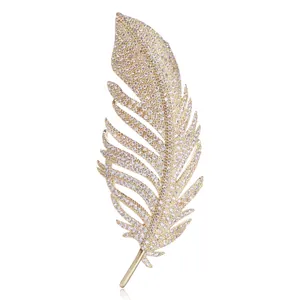 Detailed view of elegant gold feather brooch featuring shimmering zircon pavé stones