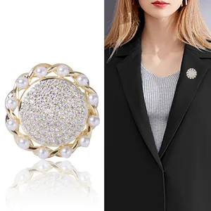 Elegant gold pearl brooch with cubic zirconia crystals for business suit decoration