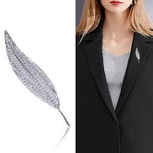 Elegant silver leaf brooch with sparkling zircons shown on a black suit lapel