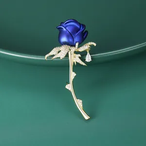 Elegant blue enamel rose brooch with golden stem, zircon accents and teardrop pendant
