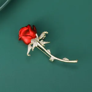 Detail of red enamel rose brooch with white zircon inlay on gold-plated petals