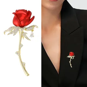 Red enamel rose brooch with zircon leaves and water drop pendant shown on black suit