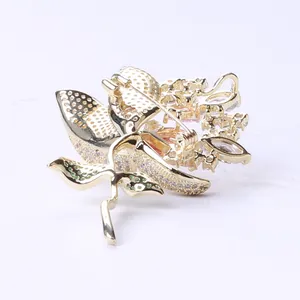 Close-up of the secure safety pin clasp and hollow back design on the luxury lotus brooch