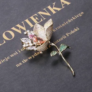 Elegant gold lotus brooch with colorful gradient zircons and green crystal leaf accents