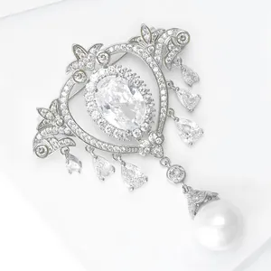 Detailed macro of baroque brooch with tassels, crystals and a large white pearl drop