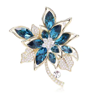 Macro detail of high-end floral crystal brooch with blue petals and golden base