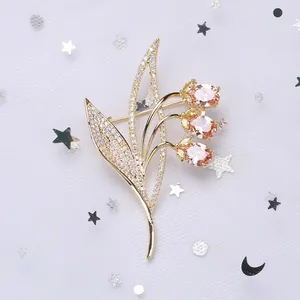 Macro detail of elegant zircon flower brooch with pink stones on a star-patterned fabric