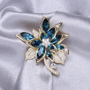 Luxurious flower brooch with navy blue marquise crystals and pavé diamonds in gold finish