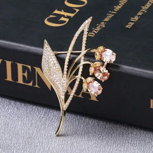 Macro shot of gold floral brooch with micro-pave zircons and champagne crystals