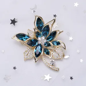 Elegant floral copper brooch with dark blue crystals and cubic zirconia in gold plating