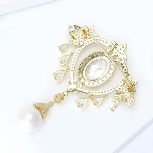 Detail of baroque brooch with gold zircon frame, crystal pendants and a large round pearl